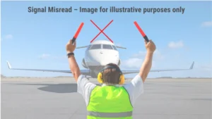 Marshaller crossing red wands with red “X” overlay—editorial metaphor for AI 171 signal failures on airport tarmac.